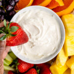 strawberry being dipped into cream cheese fruit dip