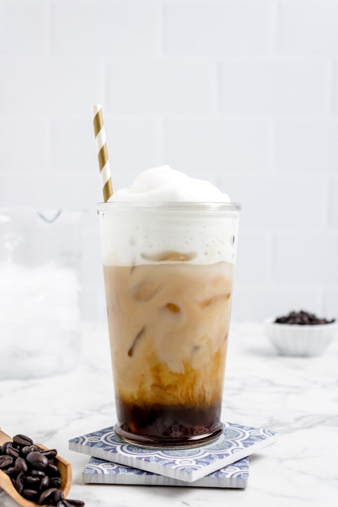Iced blonde vanilla latte in a tall glass with straw