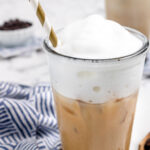 Iced blonde vanilla latte in a tall glass with straw