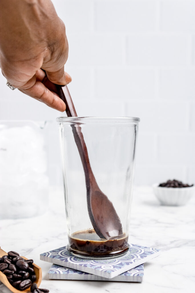 stirring the instant coffee to dissolve