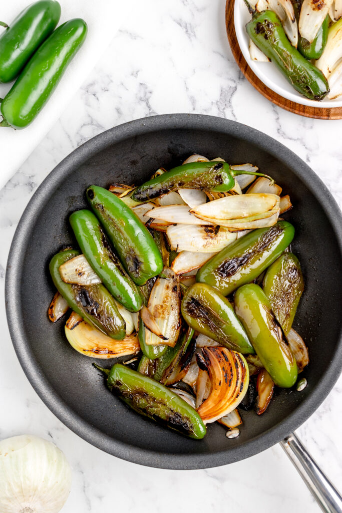 jalapenos and onions in a skillet